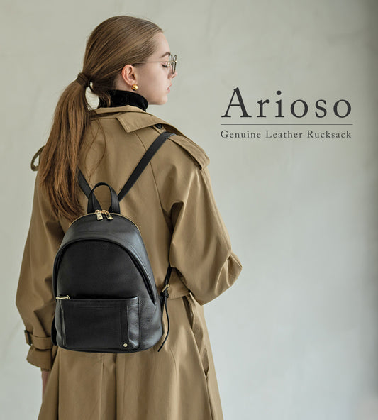A female model is carrying a backpack "Arioso". Color:Black