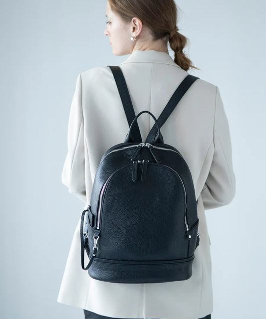 A female model is carrying a backpack "Forcoli" Color:Black