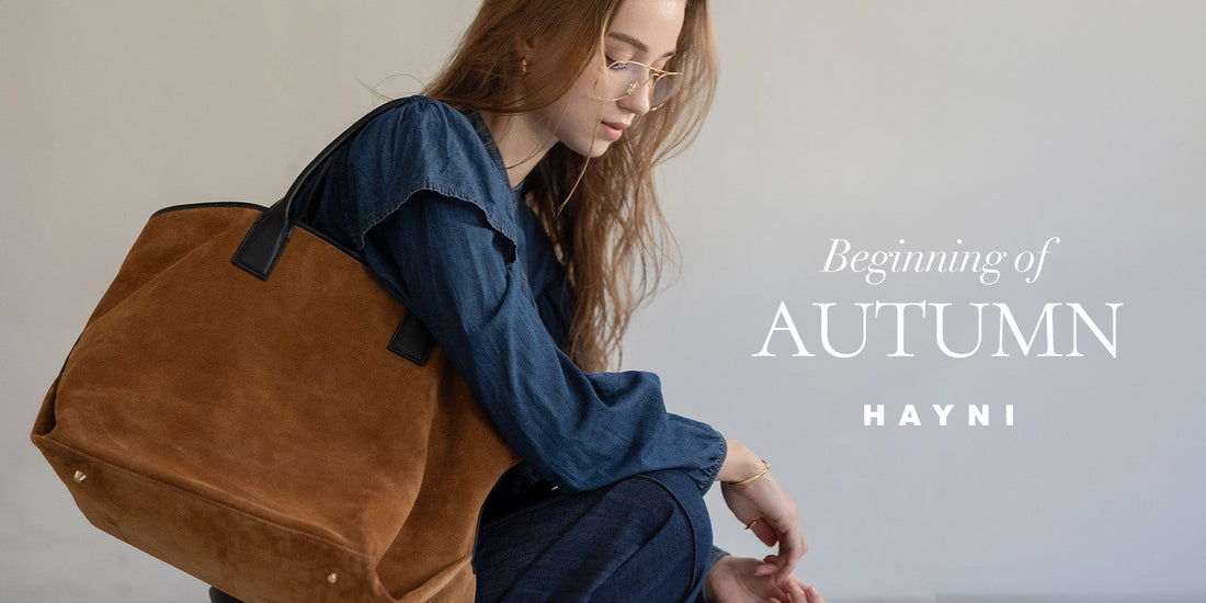 An autumn outfit styled with a brown suede bag