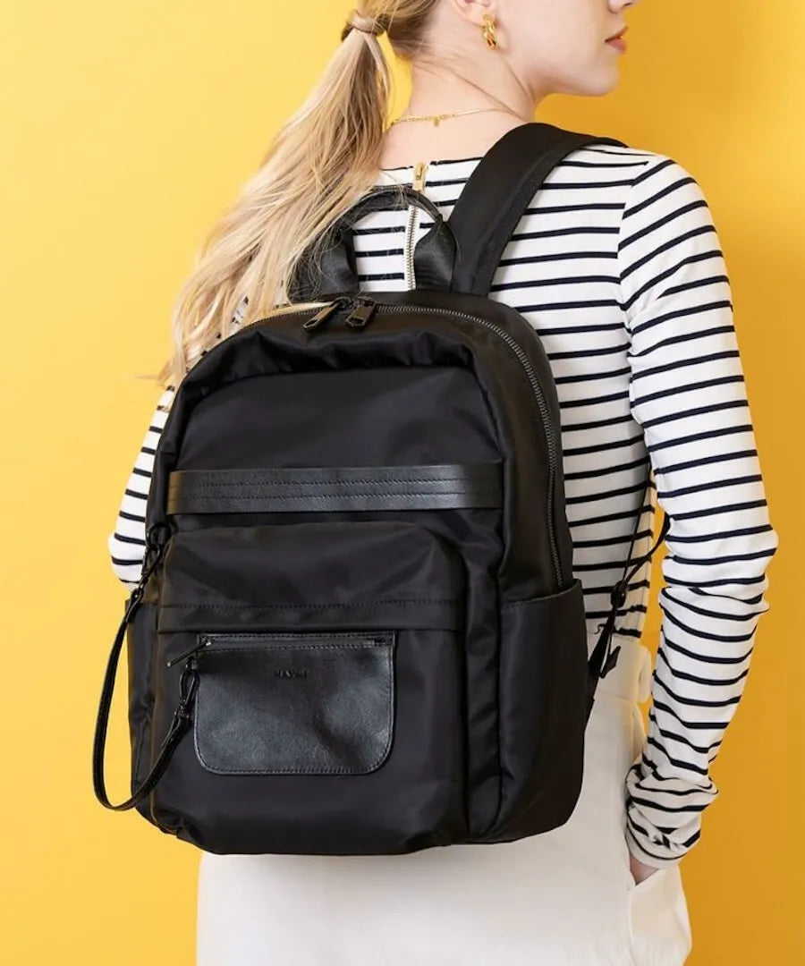 A female model carrying a backpack "Ragalo" Color:Black