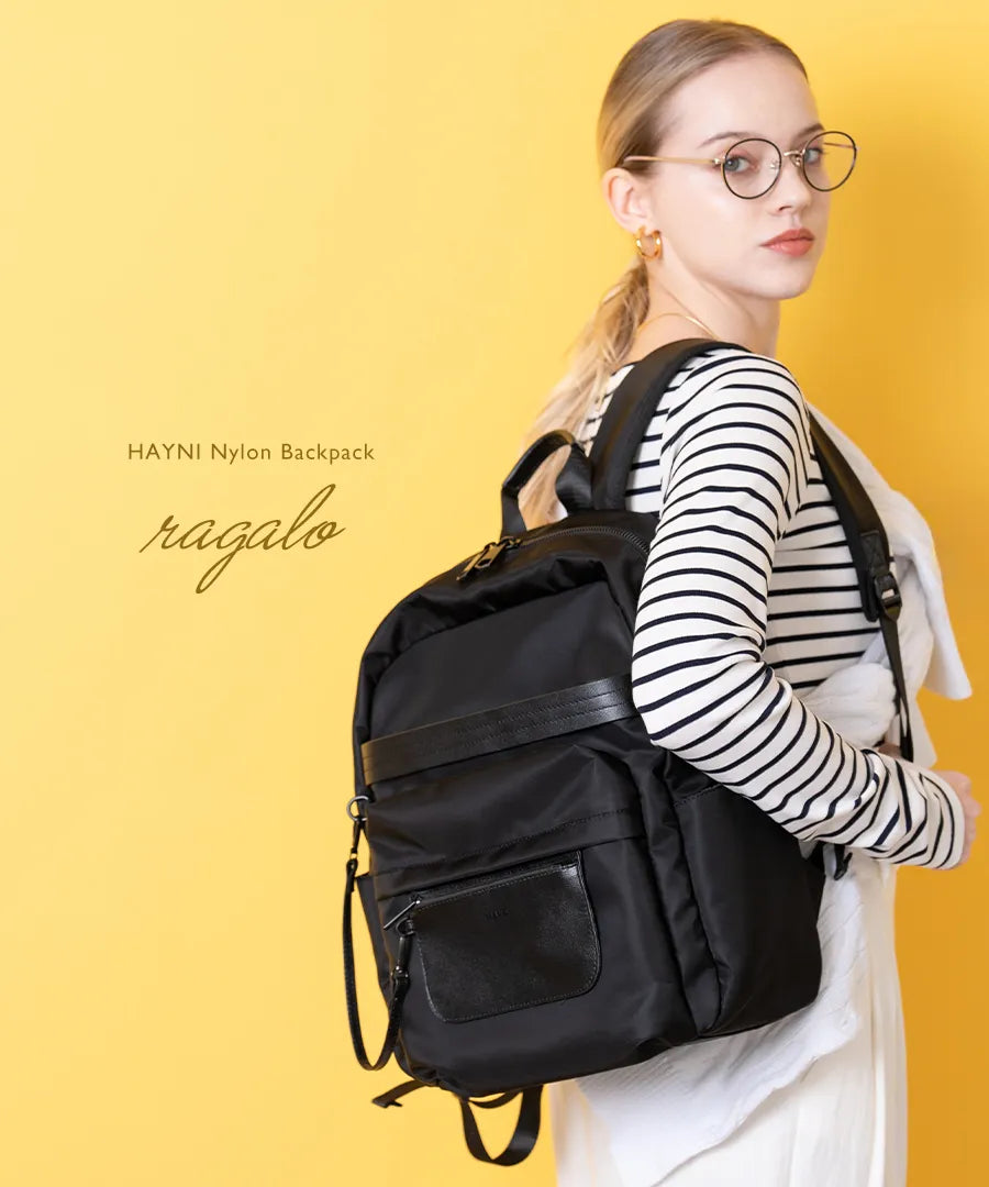 A female model carrying a backpack "Ragalo" Color:Black