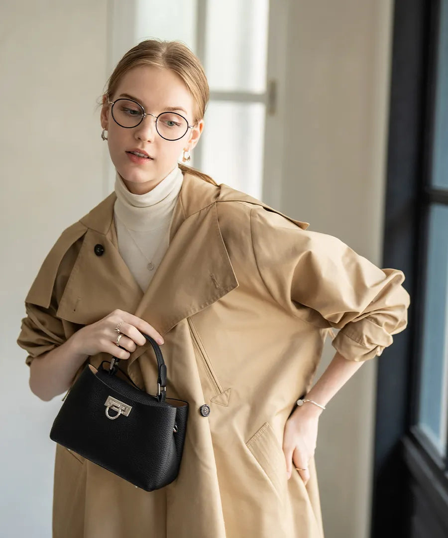 A female model is holding a tote bag "Baby Marollet". color: Black