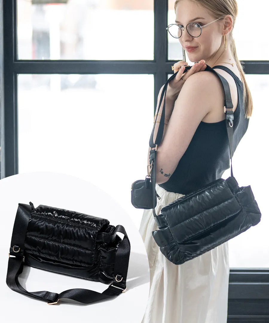 A female model is carrying a shoulder bag "Flaum" over her shoulder.