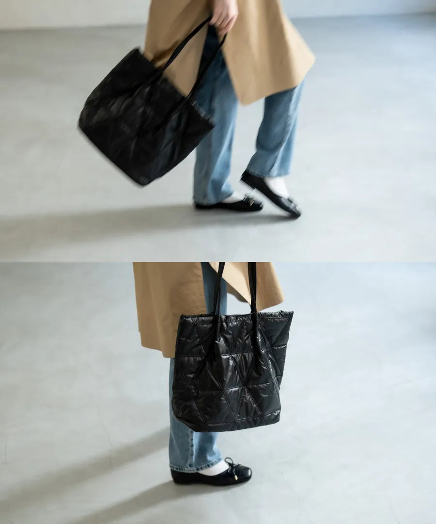 A female model is holding a quilting tote bag "Trica" Color:Black