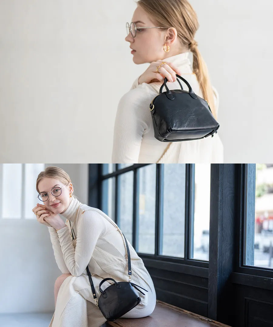 A female model is holding a bag "Light leather boston mini" Color:Black