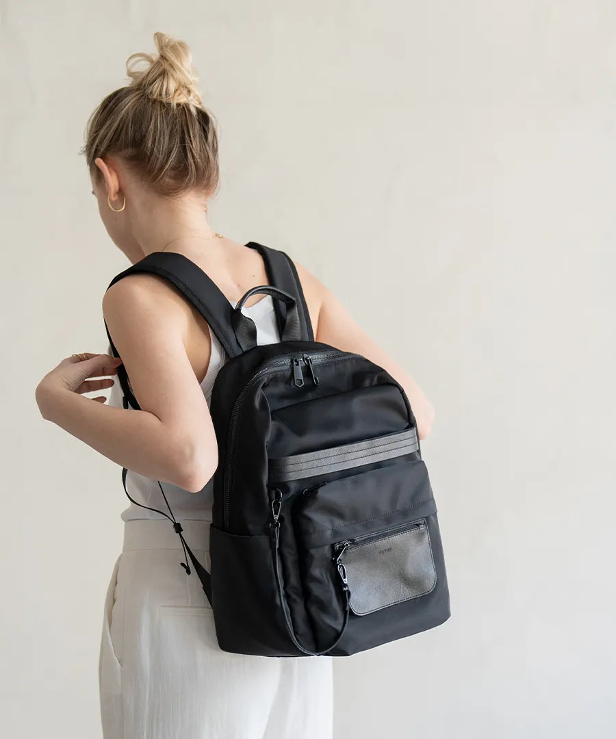 A female model carrying a backpack "Ragalo" Color:Black