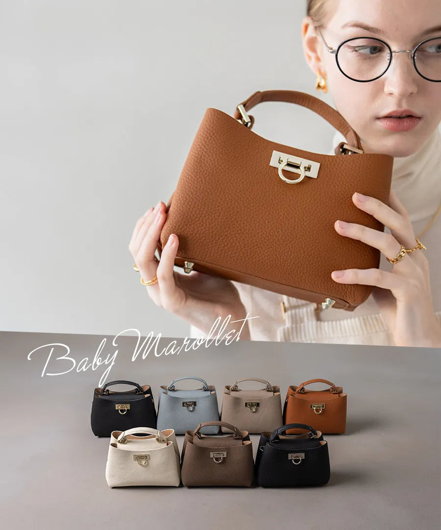 A female model is holding a tote bag “Baby Marollet”. Color:Camel