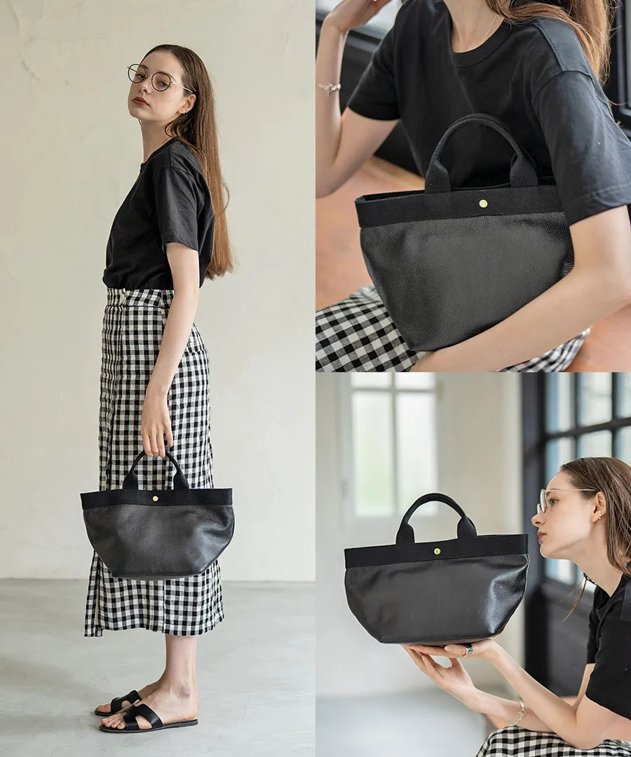 A female model is holding a tote bag "Emmalde" in colors: Black×Black.