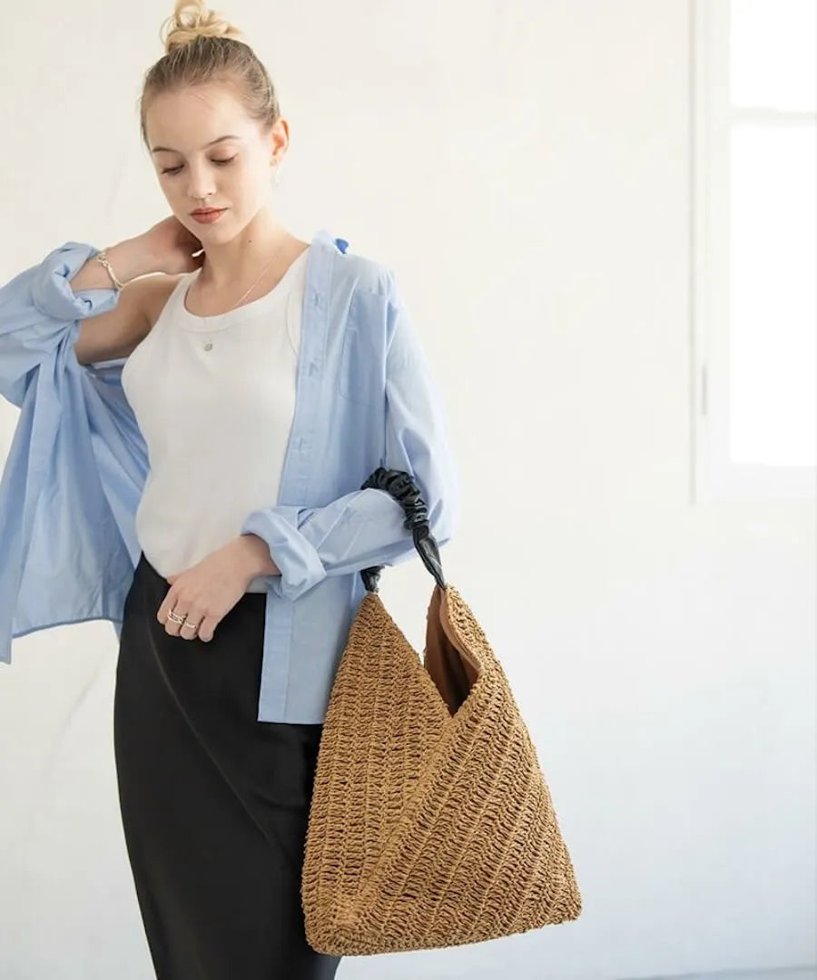 A female model is holding a tote bag "Garnea".Color:Natural camel