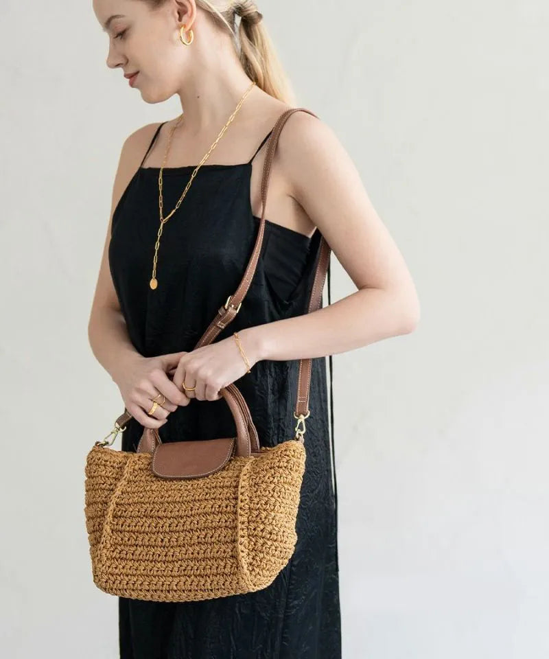 A female model is holding a tote bag "Glenda".Color:Natural × Mocha brown