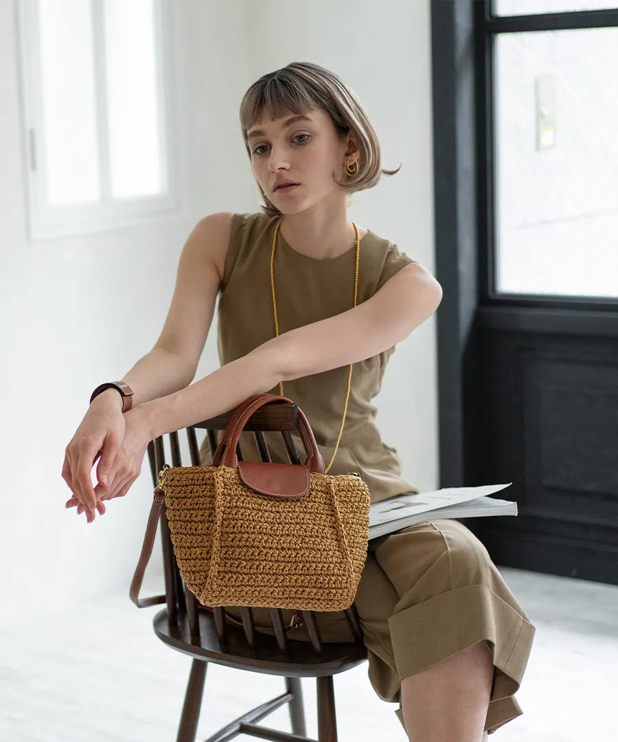 There is a bag "Glenda" next to the woman.Color:Natural × Terracotta