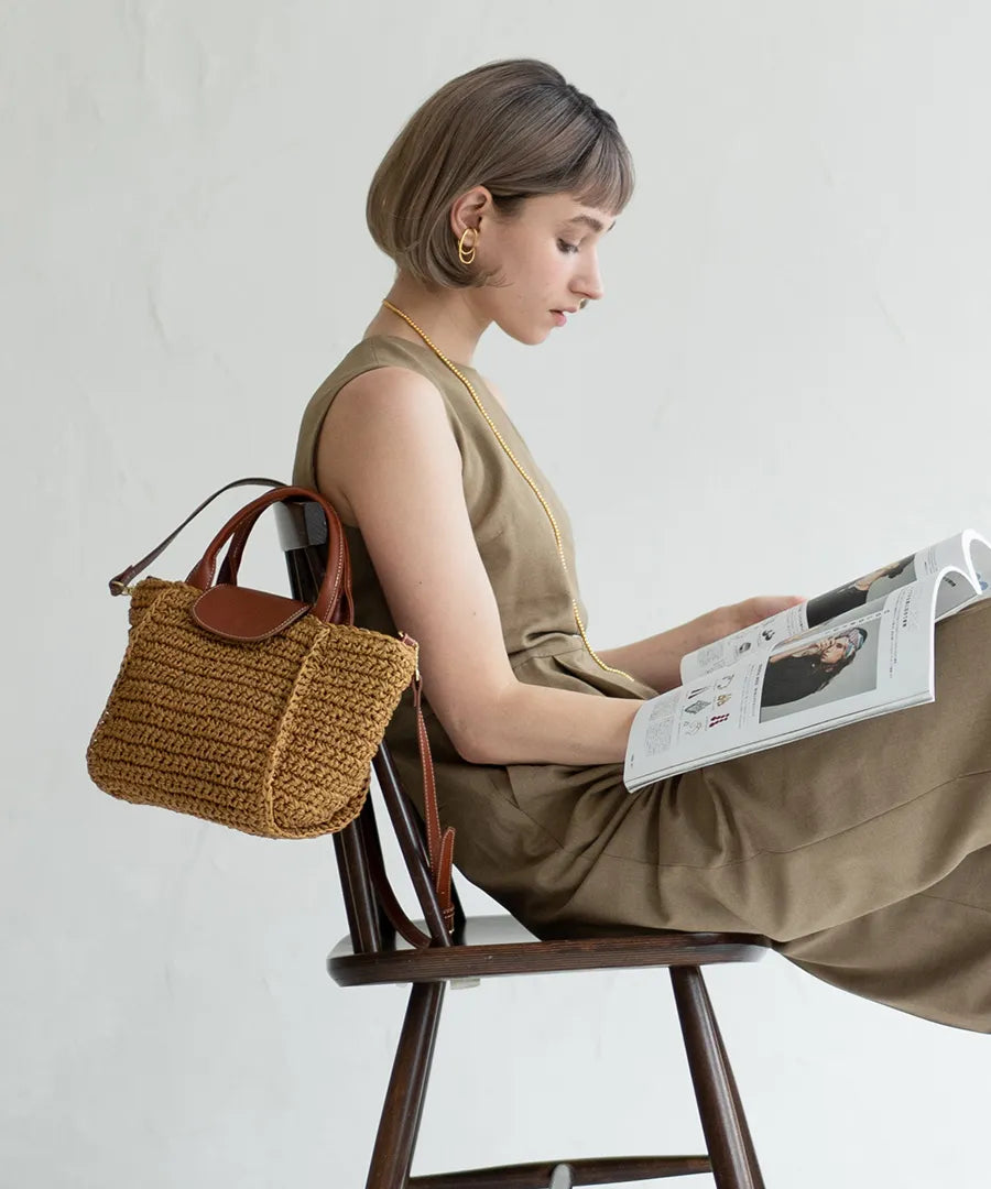 There is a bag "Glenda" next to the woman.Color:Natural × Terracotta