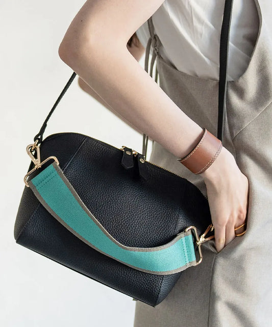 A female model is carrying a shoulder bag "Herena" over her shoulder. Color:Black