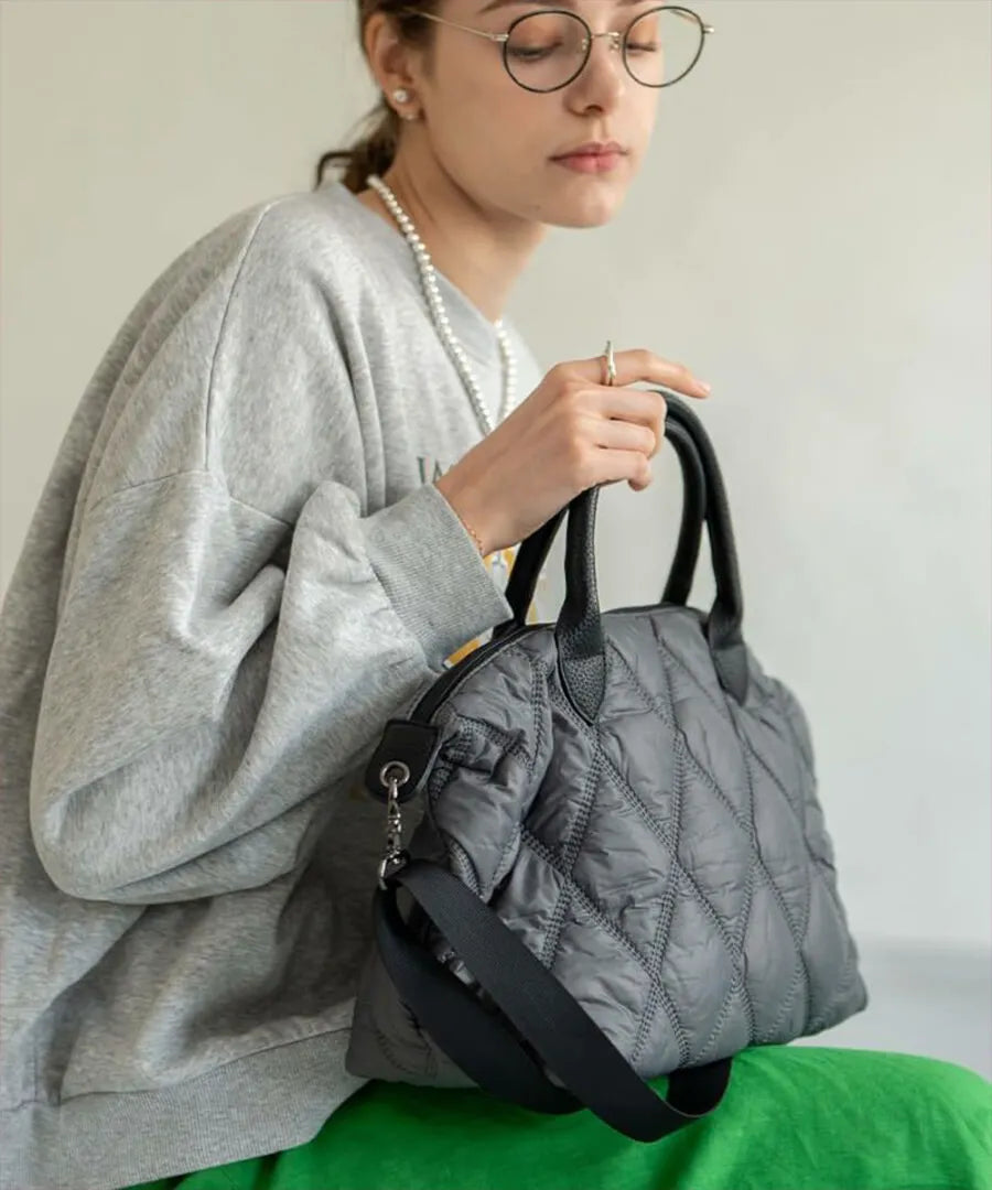 A female model is holding a hand bag "Lanef".Color:Gray