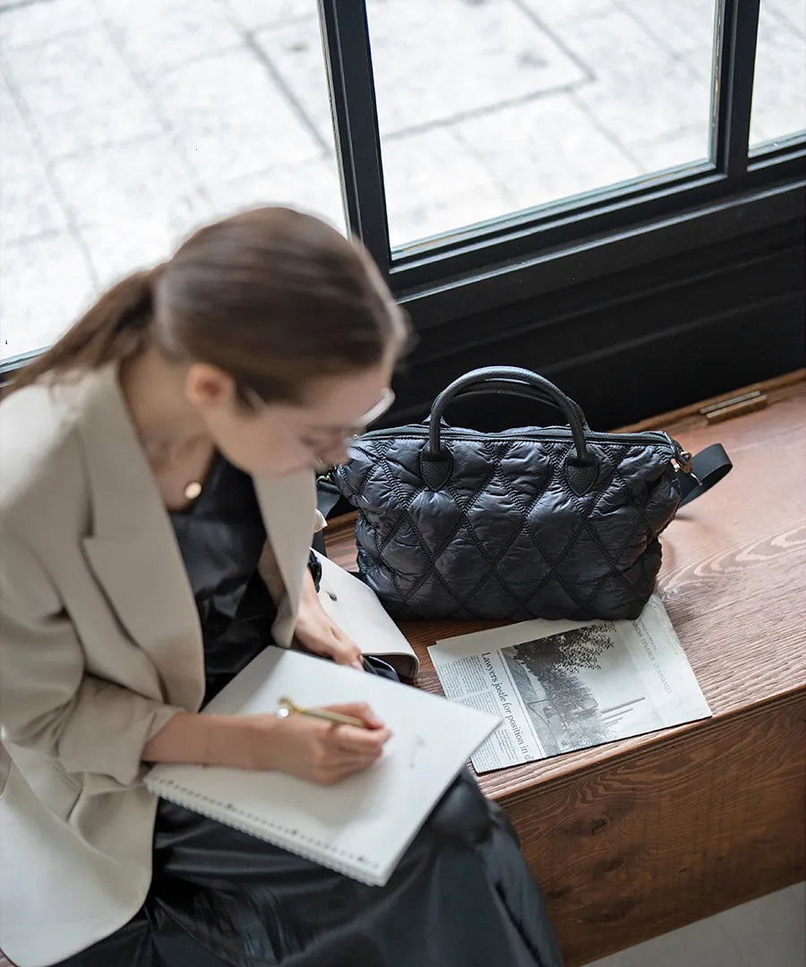 There is a bag "Lanef" next to the woman.Color:Black