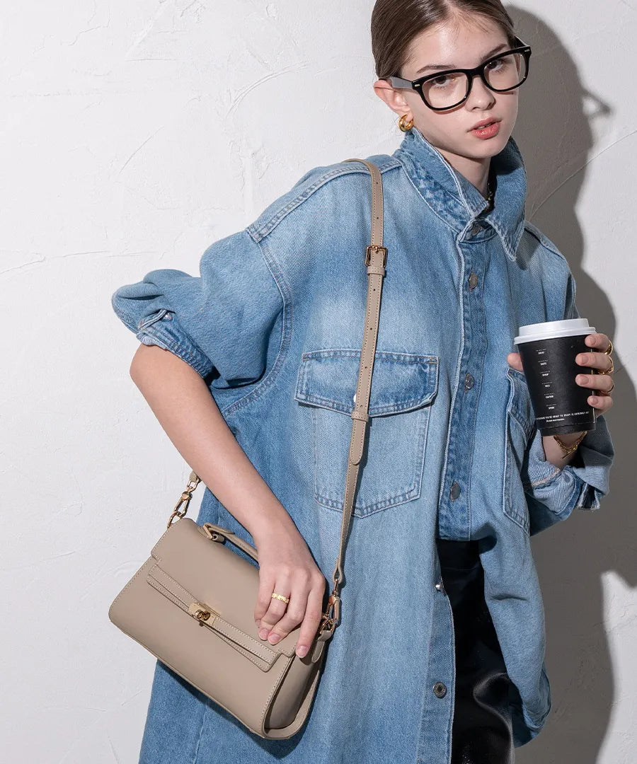 A female model is carrying a shoulder bag "Linzy" over her shoulder.	Color:Greige