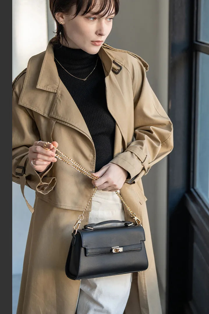 A female model is holding a hand bag "Linzy". Color:Black