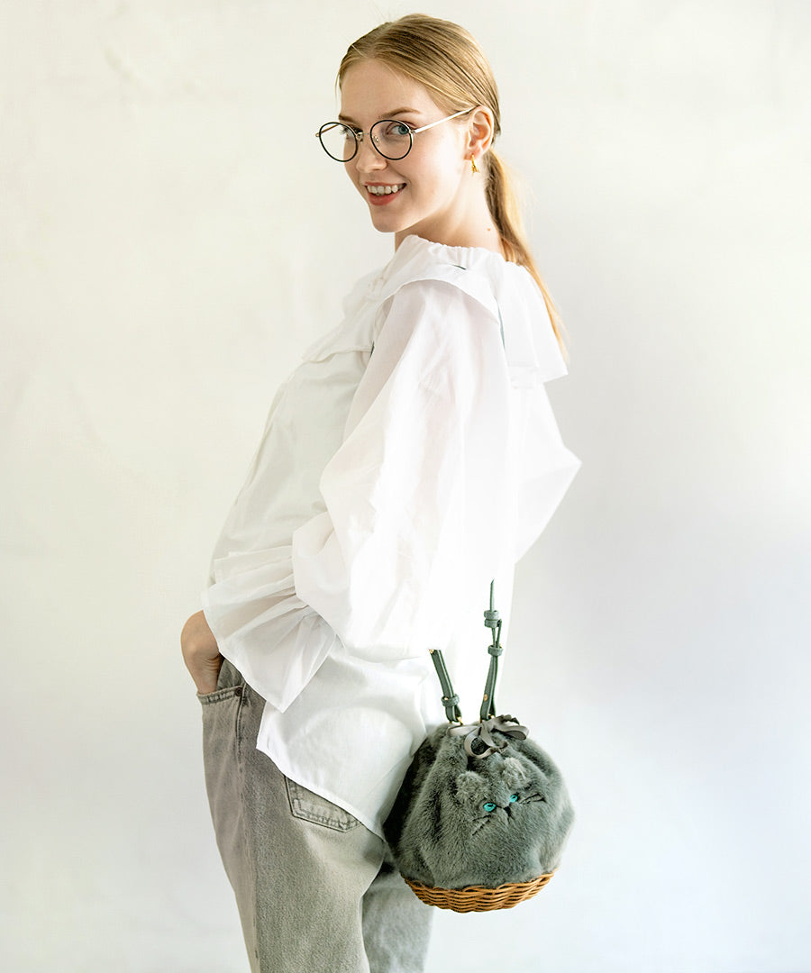 A female model is carrying a shoulder bag on her shoulder Minetpanifur". color: Aqua