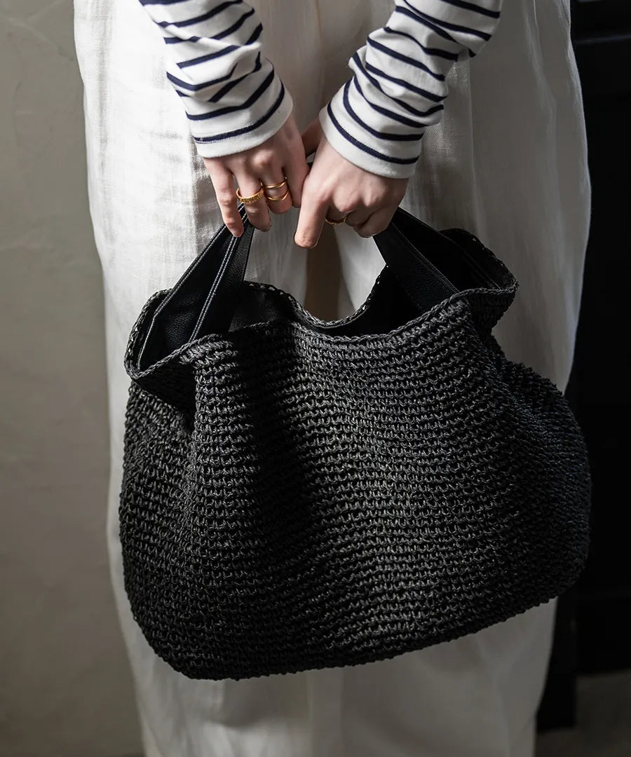 A female model is holding a hand bag "Najia".