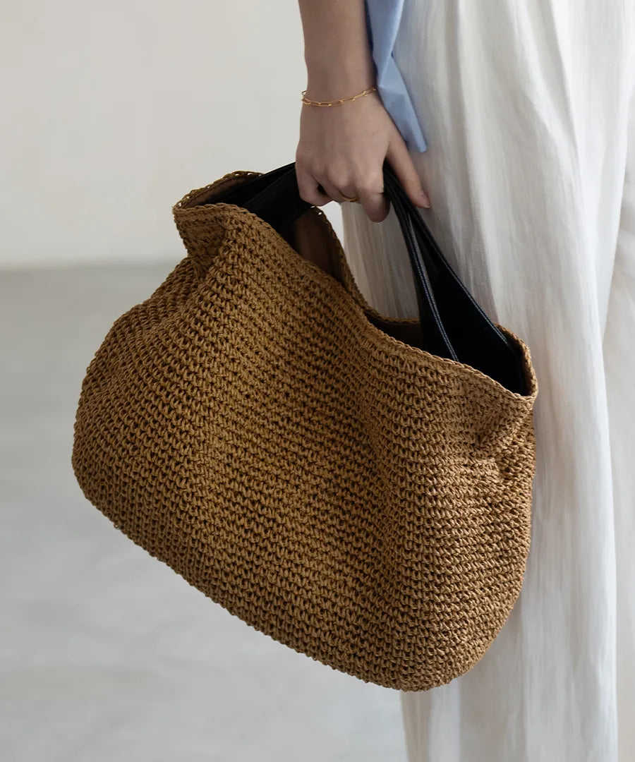 A female model is holding a hand bag "Najia".