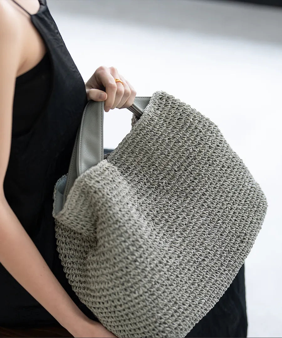 A female model is holding a hand bag "Najia".