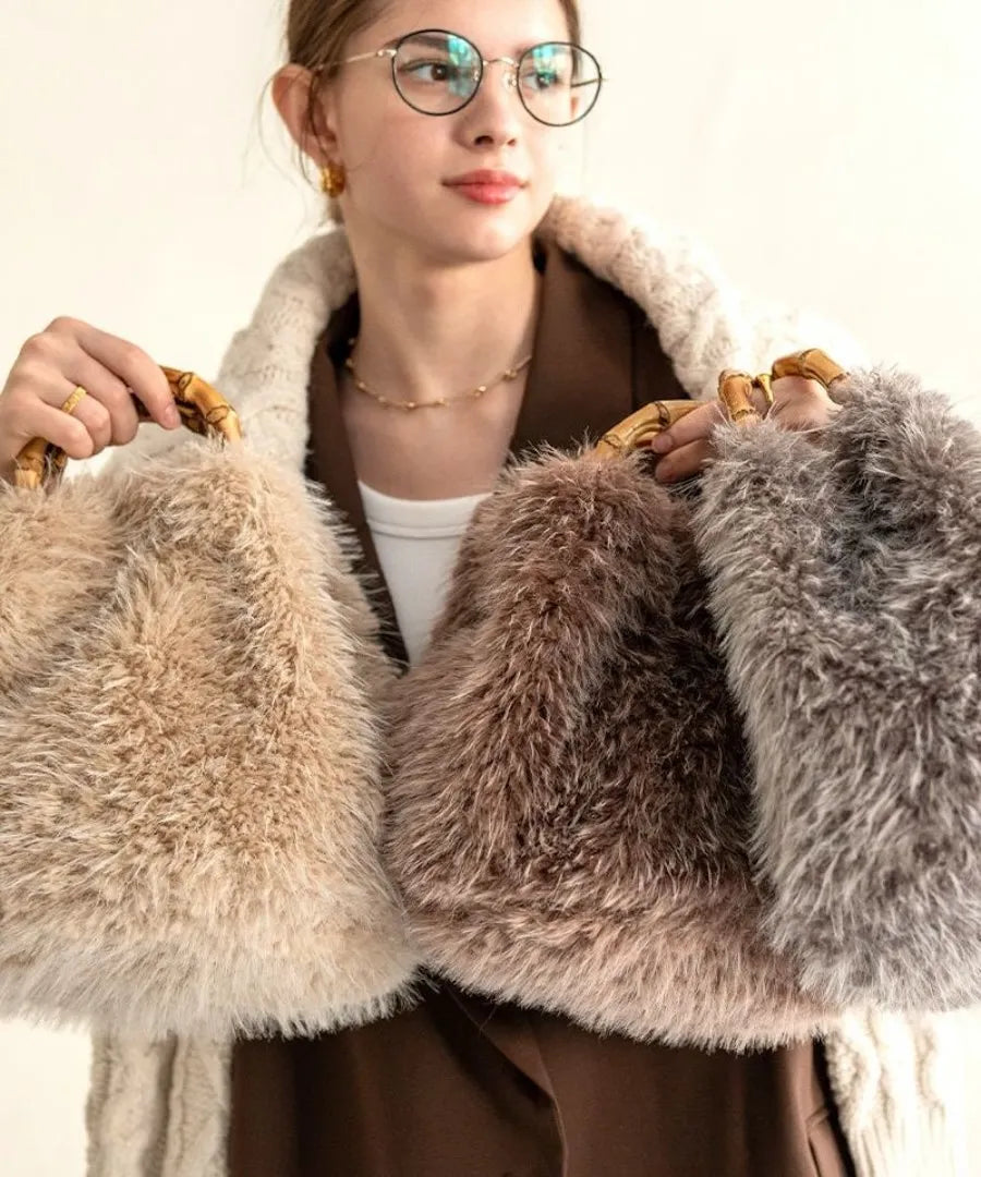 A female model is holding a fur bamboo tote bag "Sufy". Color:Mocha,Beige,Gray