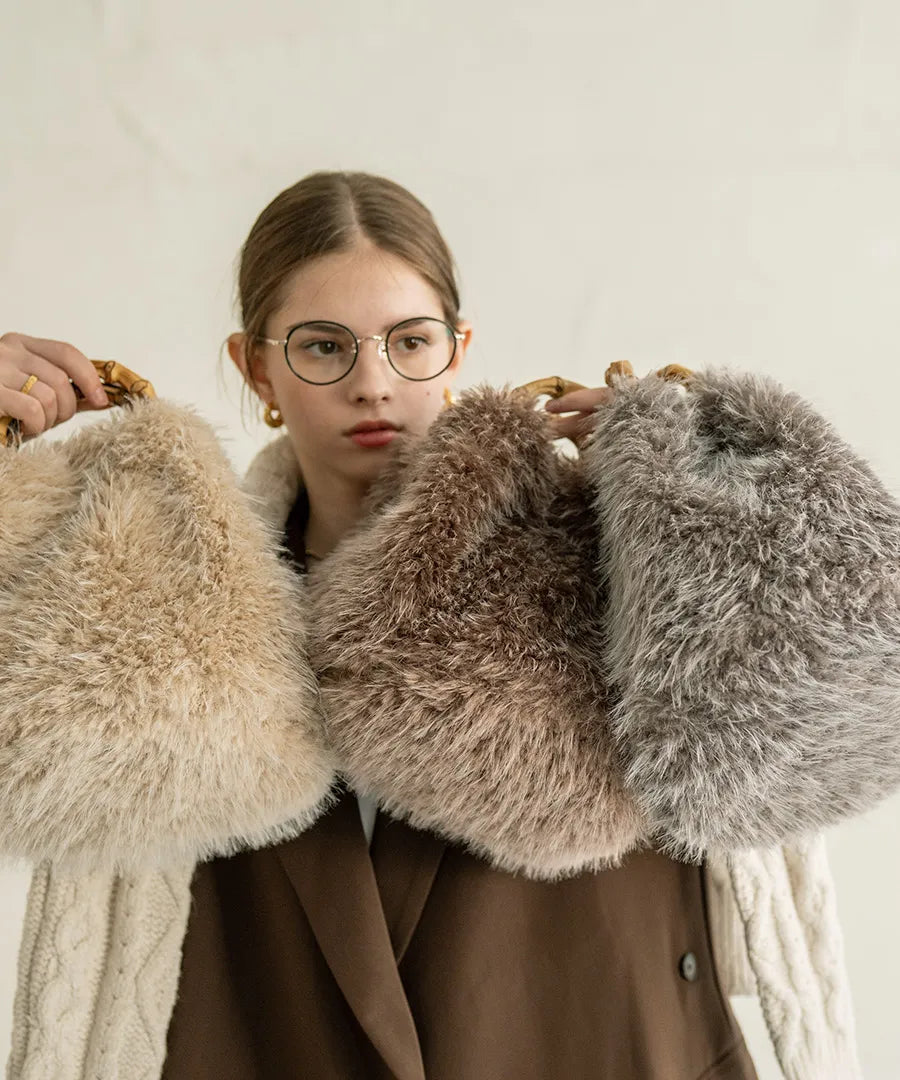 A female model is holding a fur bamboo tote bag "Sufy". Color:Mocha,Beige,Gray