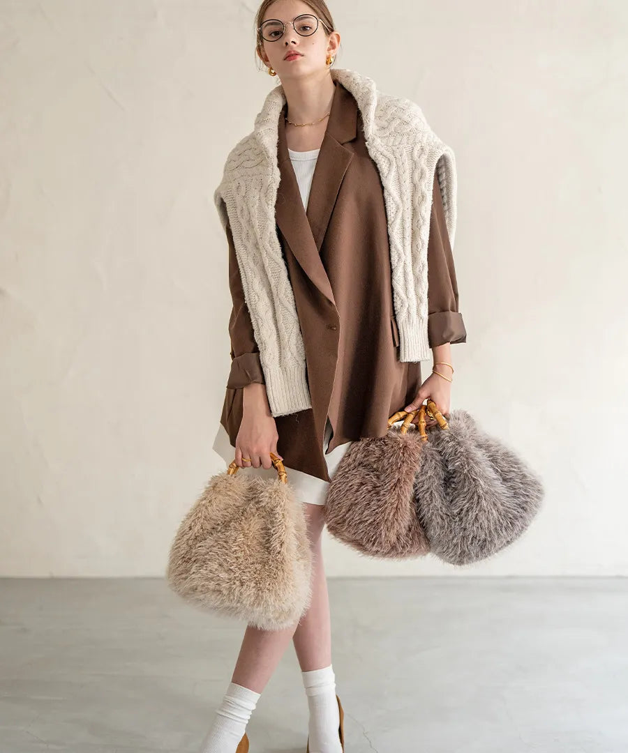 A female model is holding a fur bamboo tote bag "Sufy". Color:Mocha,Beige,Gray